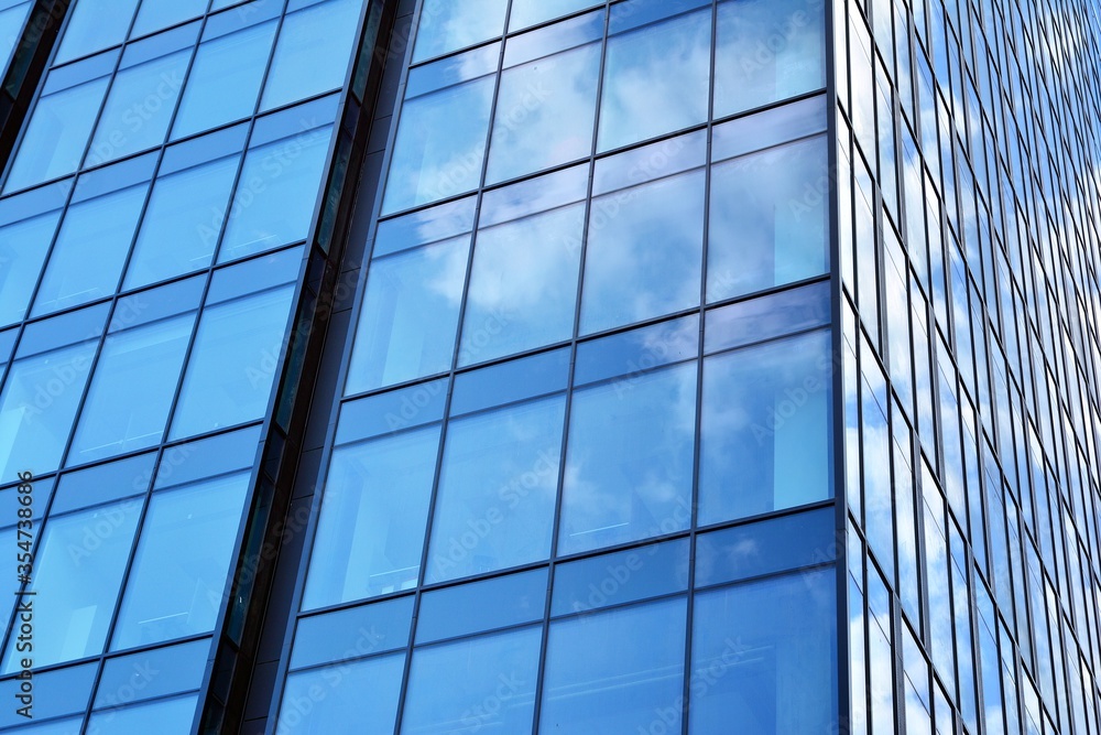 Facade texture of a glass mirrored office building. Fragment of the facade. Modern architecture of the office building. Facade texture of a glass mirrored office building. Fragment of the facade. Modern architecture of the office building.