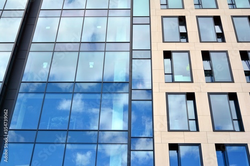 Facade texture of a glass mirrored office building. Fragment of the facade. Modern architecture of the office building.