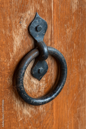 Old iron lock and bolt on the wooden door close-up