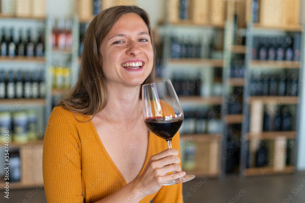 young woman brunette drinking a glass of red wine in a winebar young woman brunette drinking a glass of red wine in a winebar