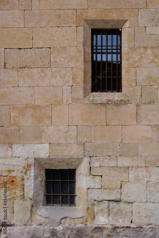Ancient old windows on marble brick wall of Salamanca spain  