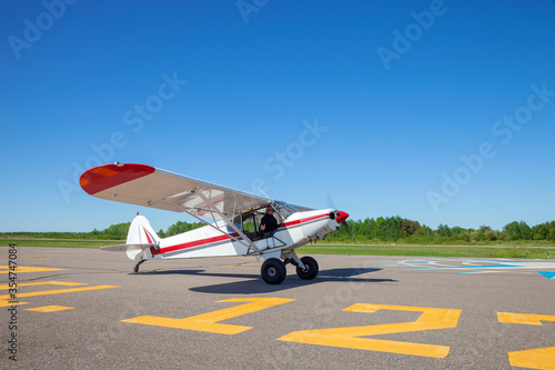Pilot in small plane taxis toward runway for take off