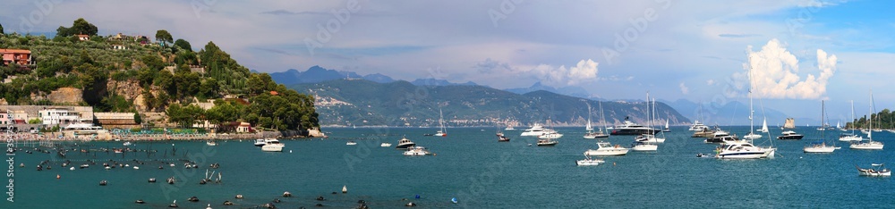 Panoramic sunset view of Italian town with boats moored in the seaport. Portovenere. Ligurian Sea. Italy.
