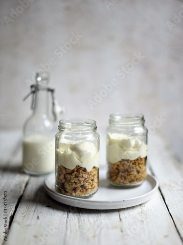 Fresh strawberries , yogurt and homemade granola for healthy breakfast on white background, selective focus.
