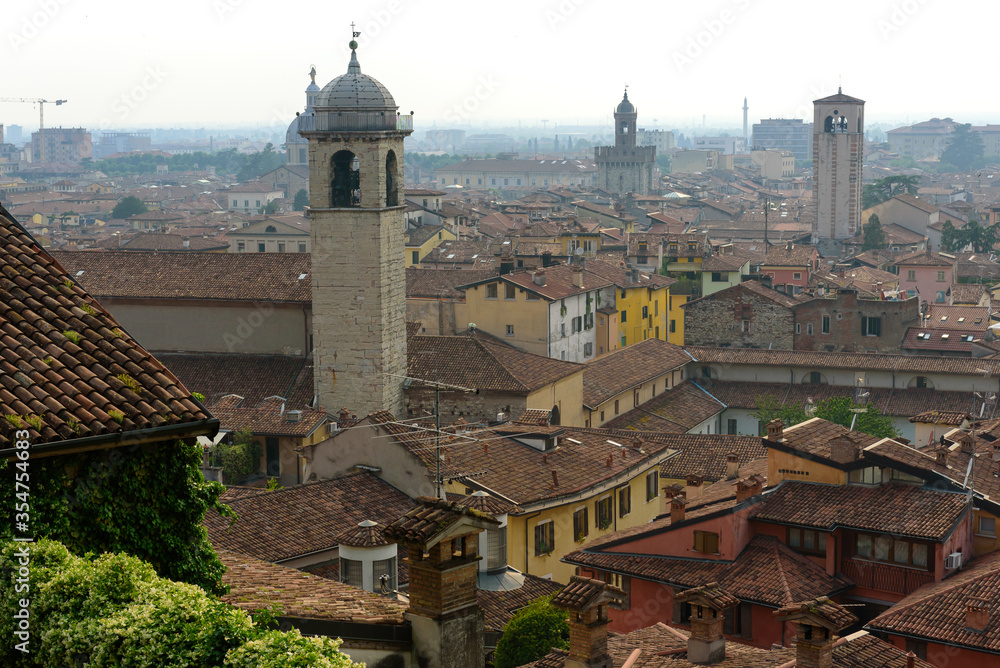 City of Northern Italy from above. Brescia, lower city. Town in northern Italy. Red Roofs and Blue Sky.