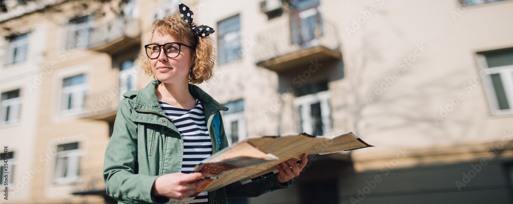 Woman tourist in european city with map