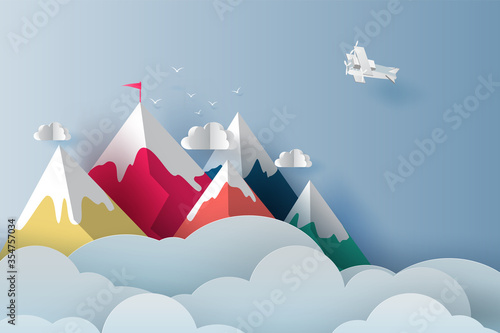 Nature Landscape Plane flying over targeted top colorful mountain with red flag on blue sky.Business success and teamwork targeted mountain concept idea. Creative Paper art and digital craft style