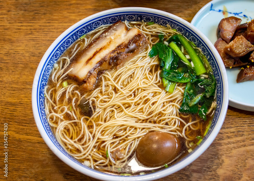 Popular China Suzhou noodle soup with pork, tea egg and vegetable.