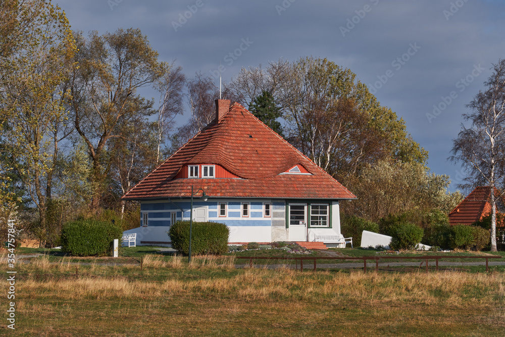 Idyllic house on the sea side on the island of Hiddensee north Germany, soft light surrounded by trees