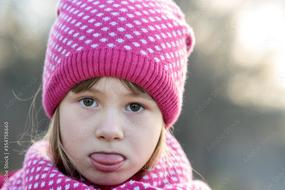 Pretty child girl in warm knitted winter clothes outdoors. Pretty child girl in warm knitted winter clothes outdoors.