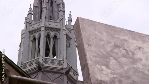 Lockdown shot of artwork against public university bell tower in city against sky - Glasgow, Scotland photo