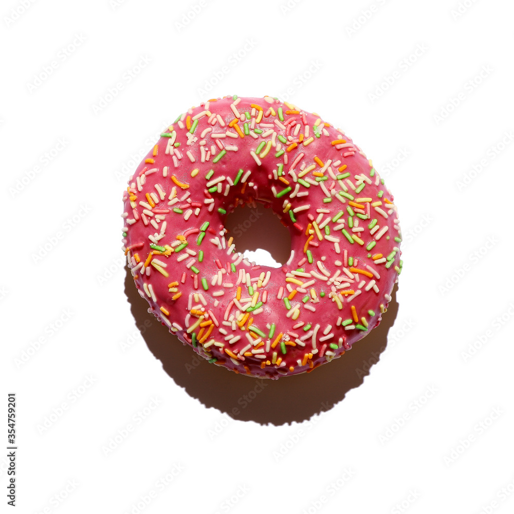 A pink donut with colored sprinkles isolated on white. Top view. Photo with harsh shadow. A pink donut with colored sprinkles isolated on white. Top view. Photo with harsh shadow.