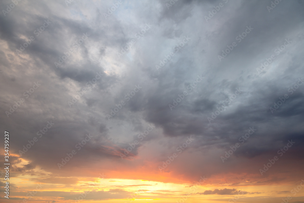 Sunset sky covered with orange puffy clouds in the evening. Sunset sky covered with orange puffy clouds in the evening.