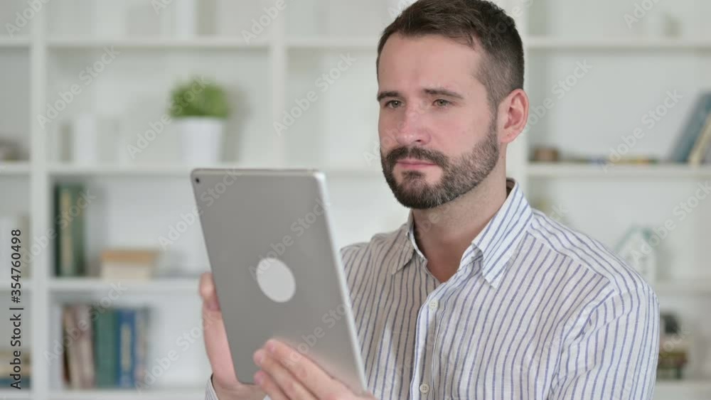 Portrait of Ambitious Young Man using Tablet Portrait of Ambitious Young Man using Tablet