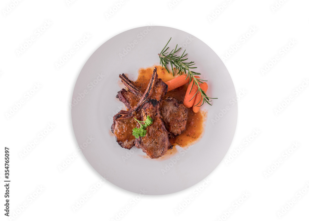 Fototapeta premium lamb steak on white plate, Rack of Lamb (ribs) with Rosemary garlic dressing, garnished with baby carrots, potatoes, and rosemary sprigs.