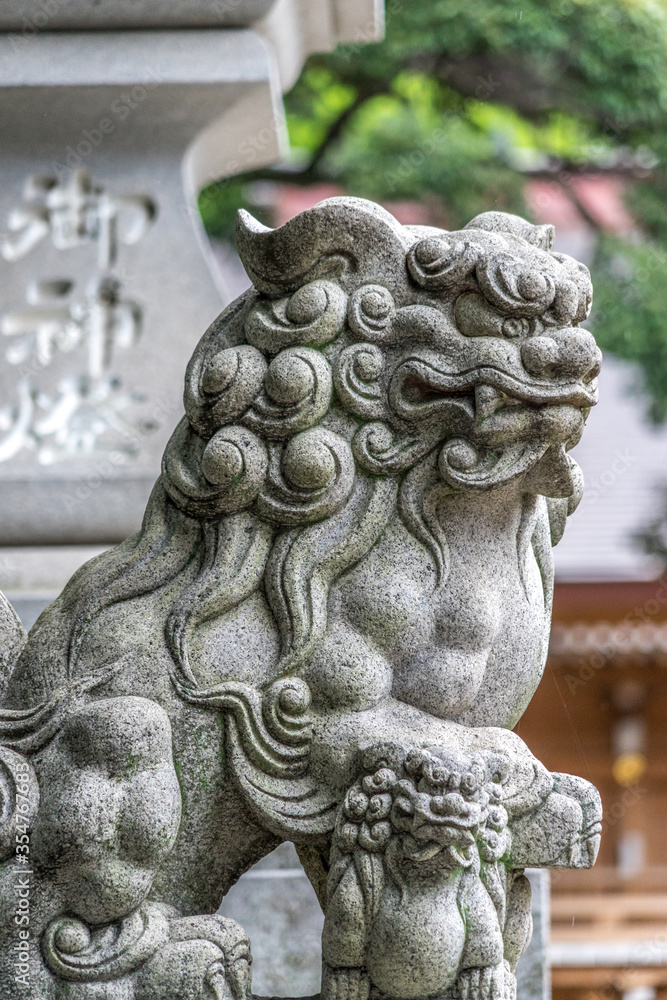 Lion-dog guardian komainu (狛犬) at the entrance of a Shrine in Tokyo, Japan Lion-dog guardian komainu (狛犬) at the entrance of a Shrine in Tokyo, Japan