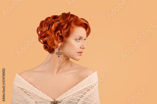 retro beauty girl curly up hairdo style posing in studio in side profile