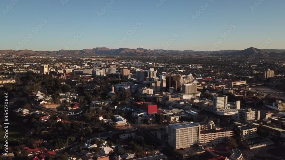 4K aerial afternoon video of savanna hills, Windhoek central business district, residential suburb, water tanks, mountains around city in central highland of Namibia, southern Africa 4K aerial afternoon video of savanna hills, Windhoek central business district, residential suburb, water tanks, mountains around city in central highland of Namibia, southern Africa