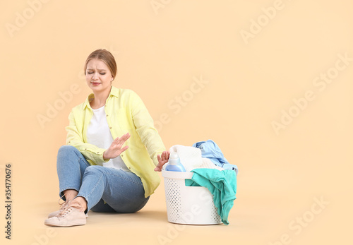 Displeased woman with laund...