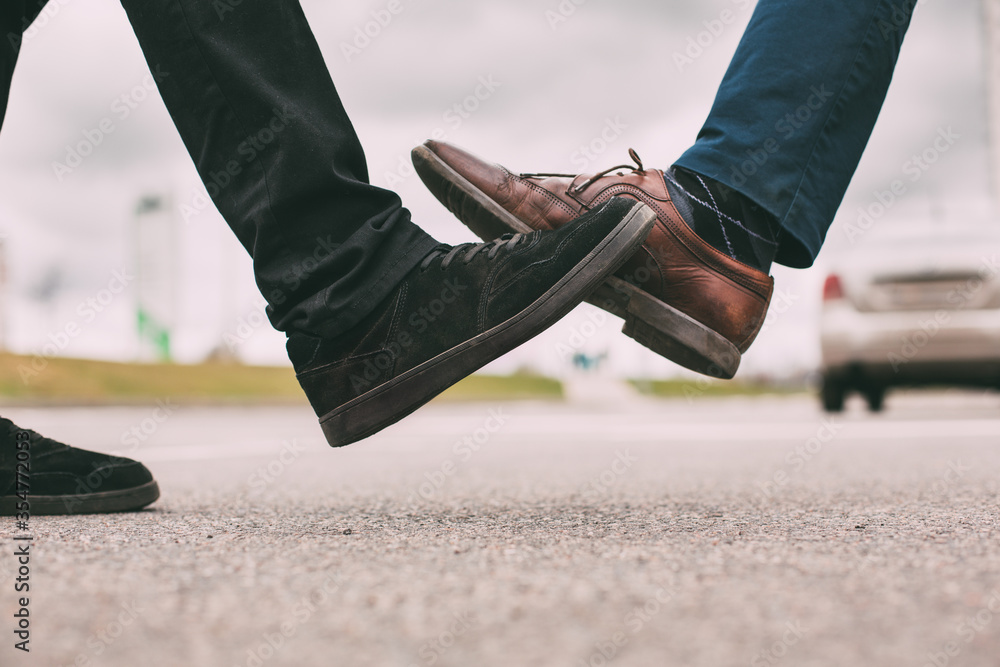 close up. two young men greeting each other on a city street.
