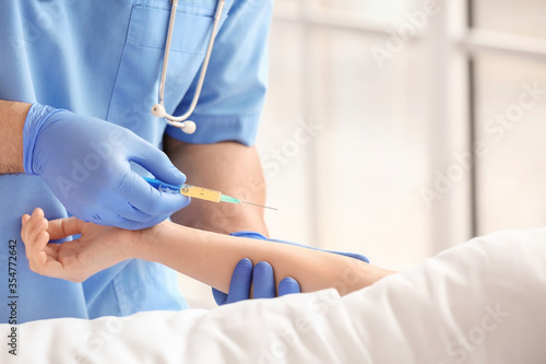 Female doctor working with patient in hospital room, closeup