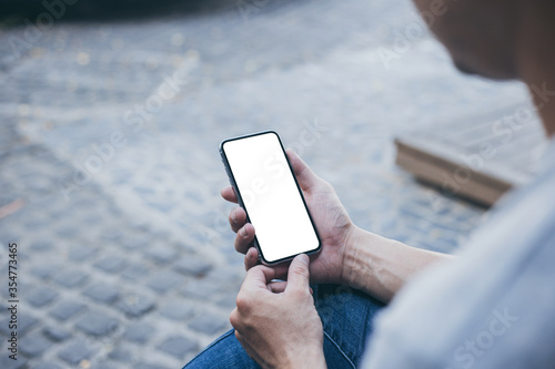 cell phone mockup image blank white screen.man hand holding texting using mobile at outdoor.background empty space for advertise.work people contact marketing business,technology