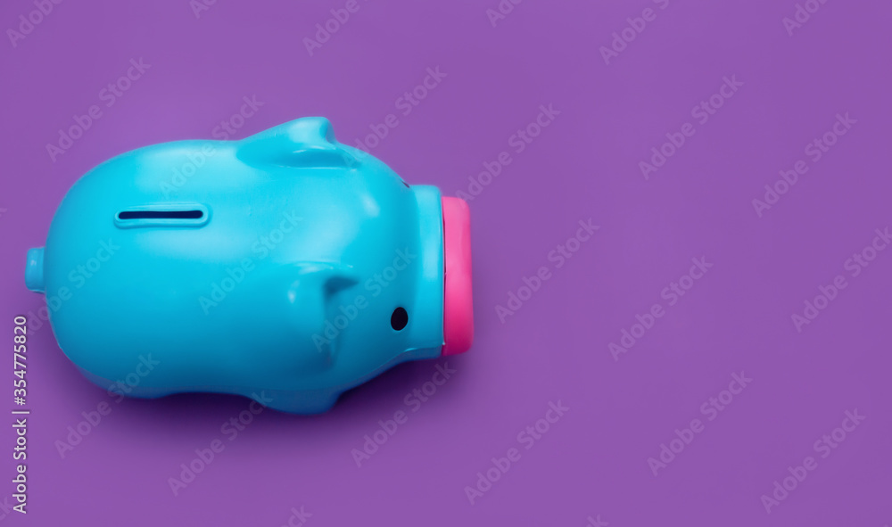 Piggy bank isolated on purple background. Money saving