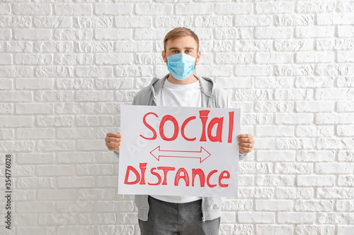 Young man holding paper wit...