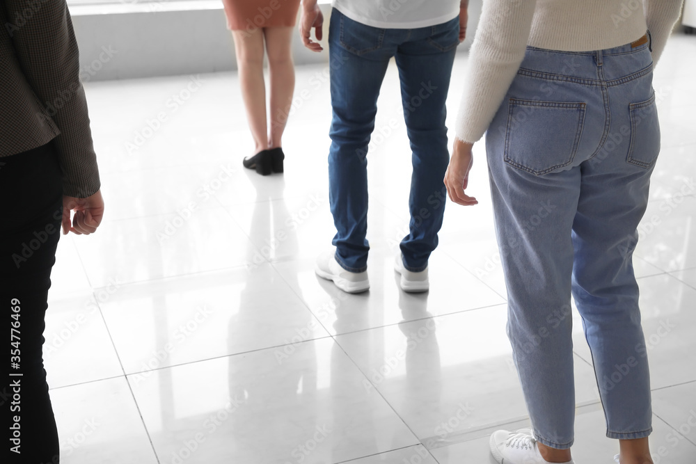 Group of people standing with social distance indoors. Concept of epidemic Group of people standing with social distance indoors. Concept of epidemic
