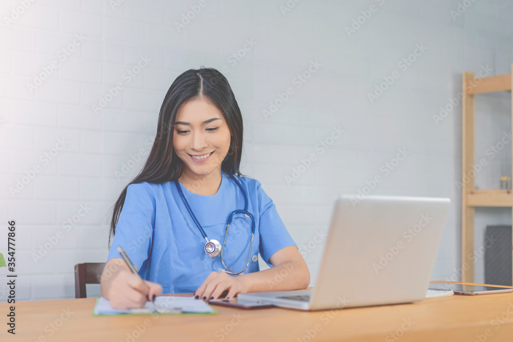 Isolation professional female Asian doctor working on laptop , writing a coronavirus positive patient a prescription hydroxychloroquine sulfate tablets.pandemic infection outbreak Coronavirus Medical Isolation professional female Asian doctor working on laptop , writing a coronavirus positive patient a prescription hydroxychloroquine sulfate tablets.pandemic infection outbreak Coronavirus Medical