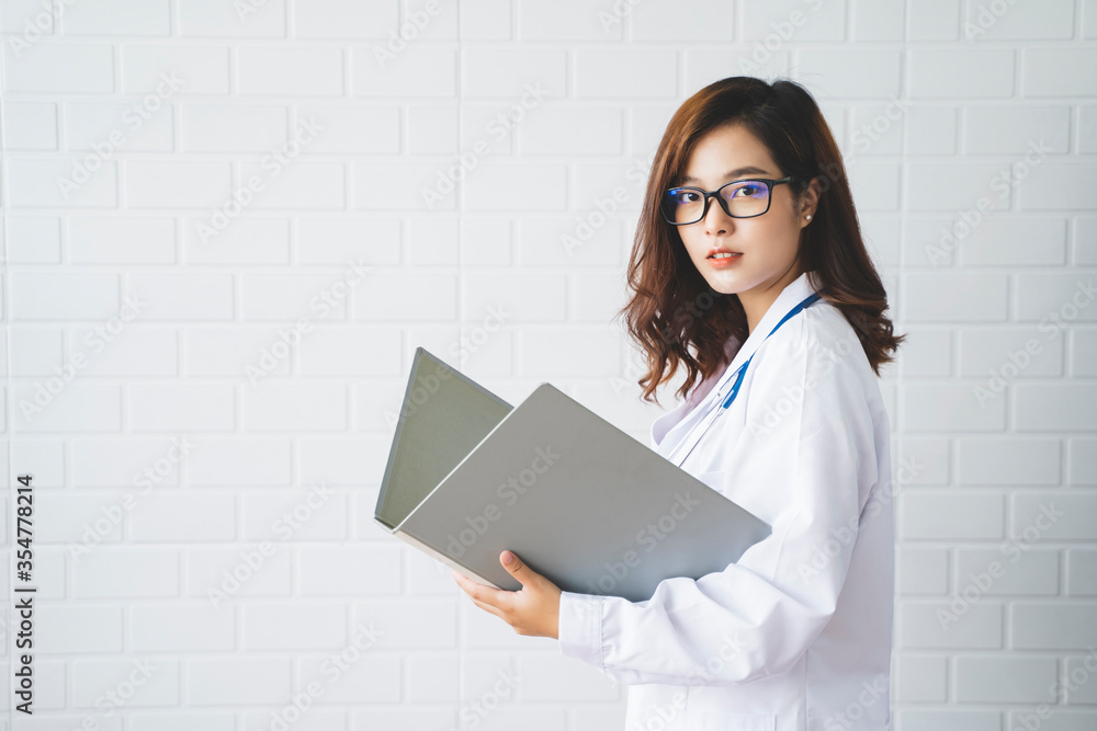 Medical health clinic beautiful Asian doctor working researching files information, stethoscope diagnosing patient analysis research examination healthcare provider service insurance in modern office Medical health clinic beautiful Asian doctor working researching files information, stethoscope diagnosing patient analysis research examination healthcare provider service insurance in modern office