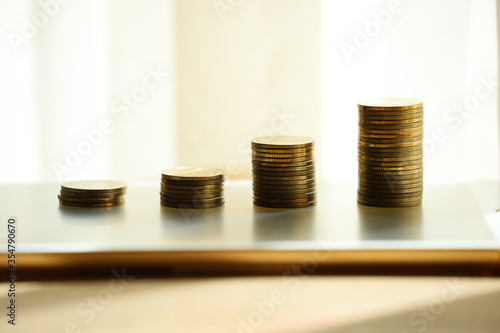 Close up of step of coins stack with blur background as business financial growth and benefit earning from capital investment concept