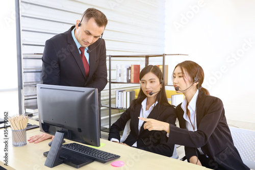 Business call center team working in office room and using headphone for customer consulting, smart online