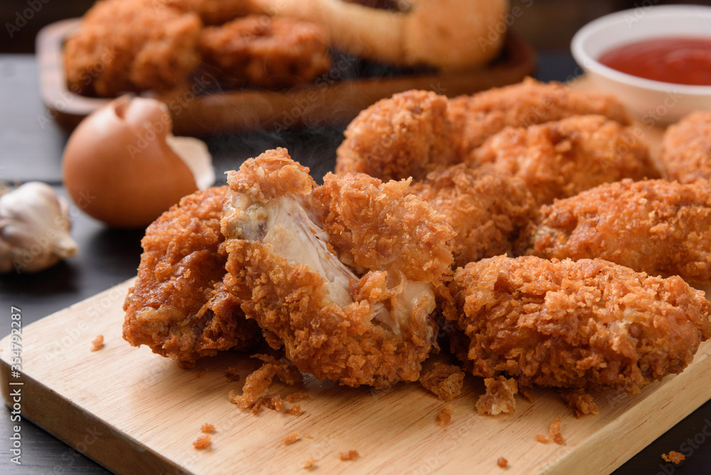 Fried breaded chicken wings on wooden table. Close up Fried breaded chicken wings on wooden table. Close up