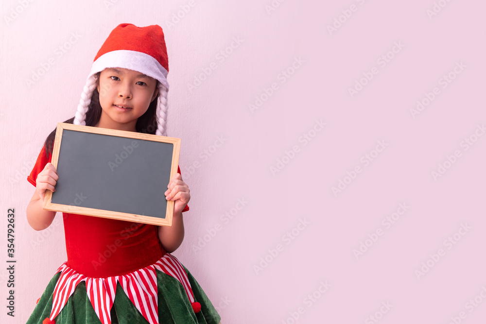 Asian girl in Elf clothes holding empty board. Merry christmas Asian girl in Elf clothes holding empty board. Merry christmas