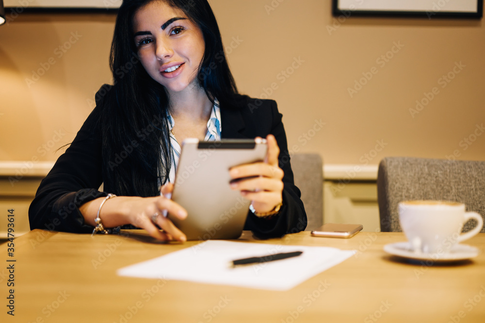 Successful female entrepreneur using touchpad for checking email box in application Successful female entrepreneur using touchpad for checking email box in application