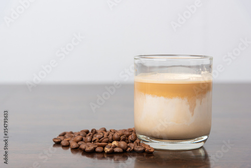 coffee latte with coffee bean on wooden table.