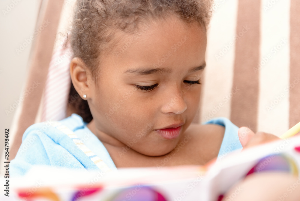Little girl drawing at home sitting on chair. Little girl drawing at home sitting on chair.