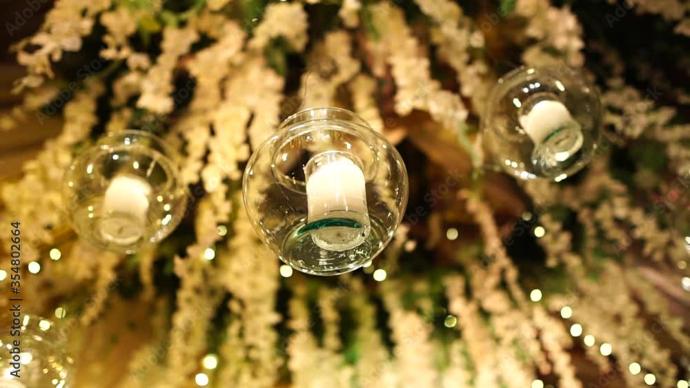 Candle light hanging on the ceiling inside of a jar, beautiful decoration in venue, closeup Candle light hanging on the ceiling inside of a jar, beautiful decoration in venue, closeup