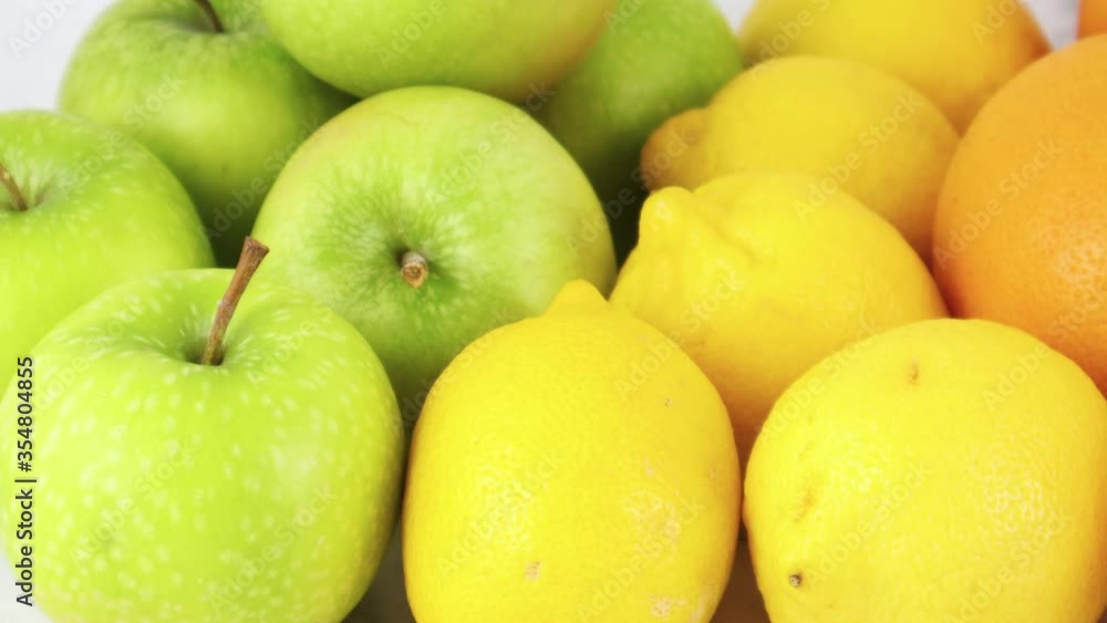 Close up of ordered fresh oranges, lemons and green organic apples Close up of ordered fresh oranges, lemons and green organic apples