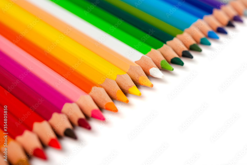 Multicolored pencils isolated on a white background. Free space for text. Education frame concept. Multicolored pencils isolated on a white background. Free space for text. Education frame concept.