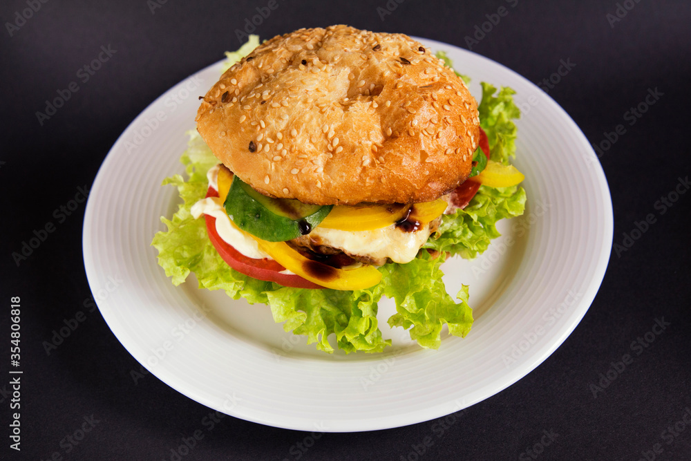 
Burger with beef patty tomato and vegetables with lettuce