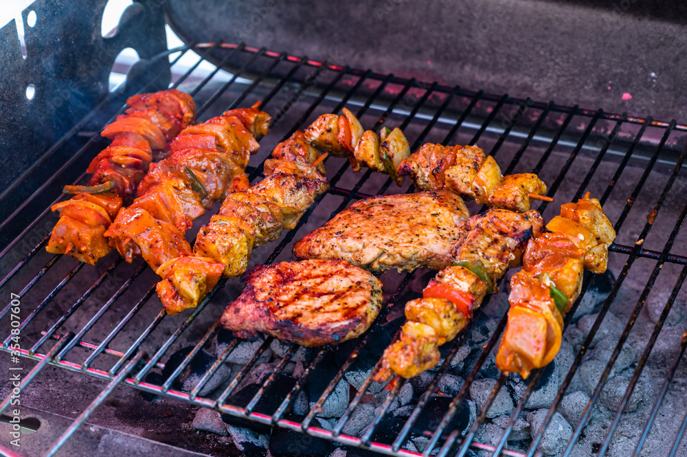 A closeup of barbecue on an outdoor grill under the sunlight - perfect for food concepts