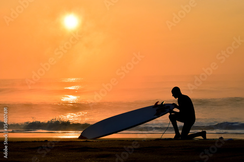 Silhoette Surfer on a misty beach in Chiba Japan with a stunning sunrise and waves. Lifestyle,surfboard,surfing,Japansurf photo