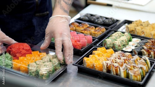 Sushi and rolls set in a plastic box. Delivery service consept photo