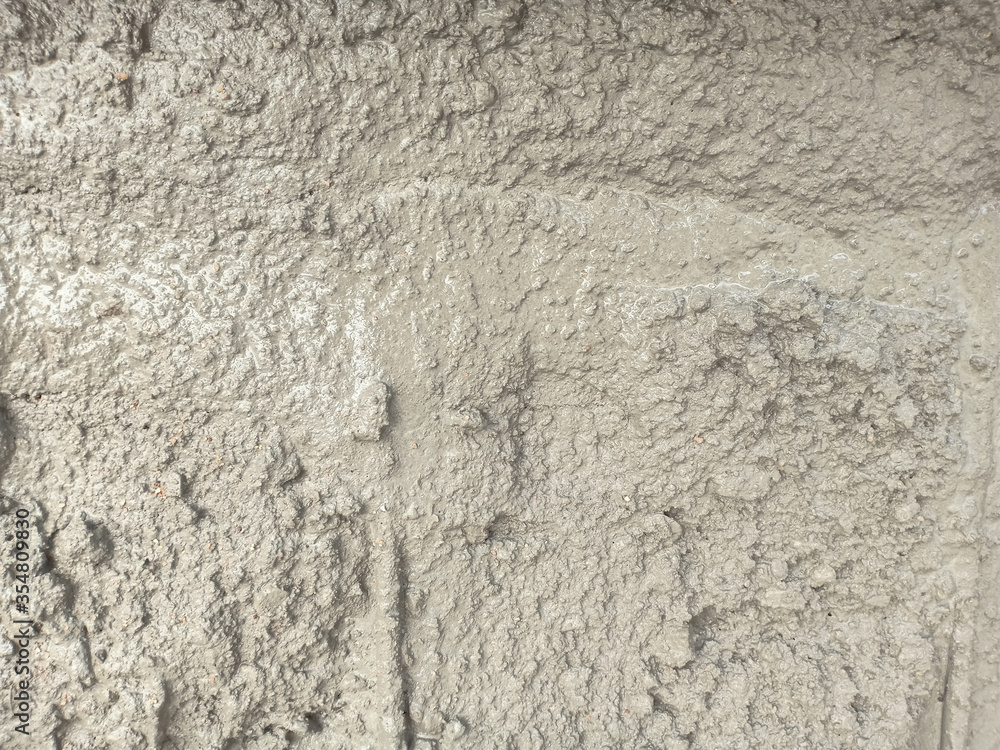 Wet rough concrete floor as texture background. Wet rough concrete floor as texture background.