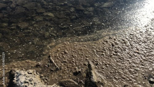 Dirt on the surface of the water. River pollution by industrial waste.