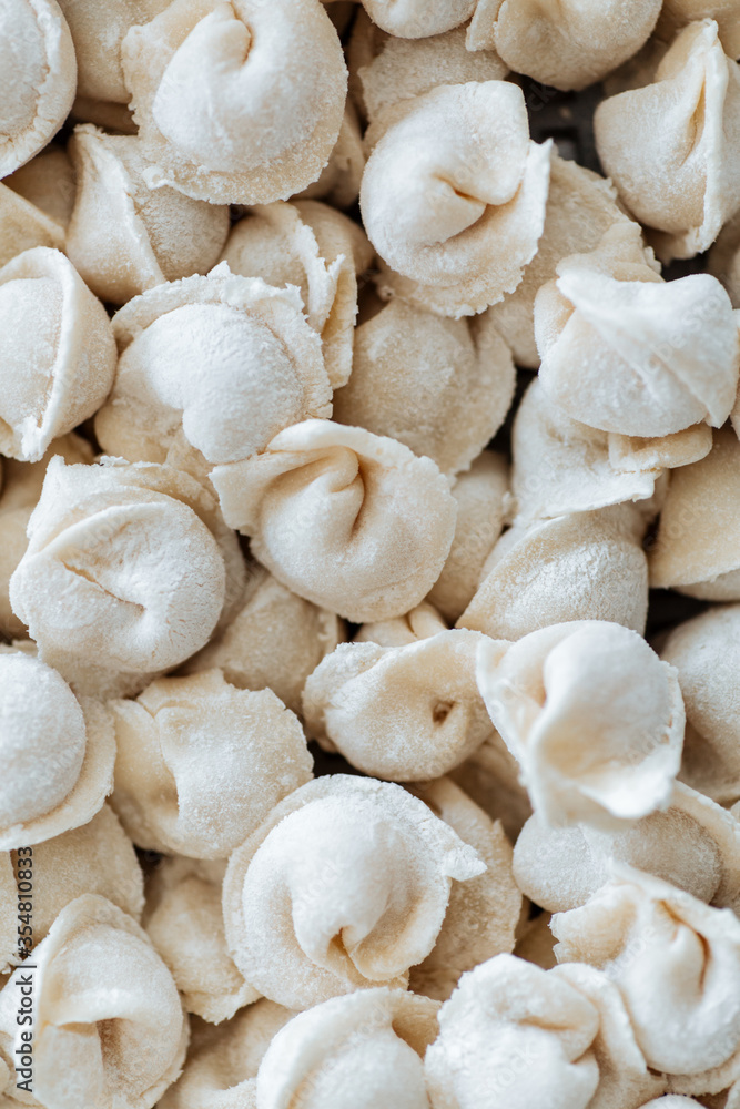 Raw dumplings. Russian national food. Sprinkled with flour Raw dumplings. Russian national food. Sprinkled with flour