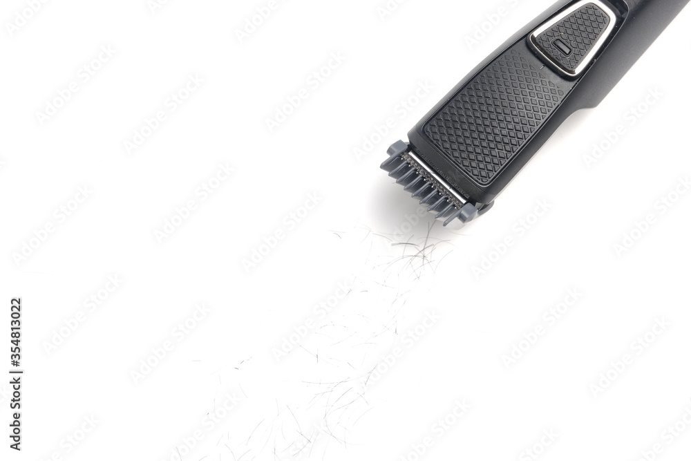A part of beard trimmer with cut hair insight on isolated white background. A part of beard trimmer with cut hair insight on isolated white background.