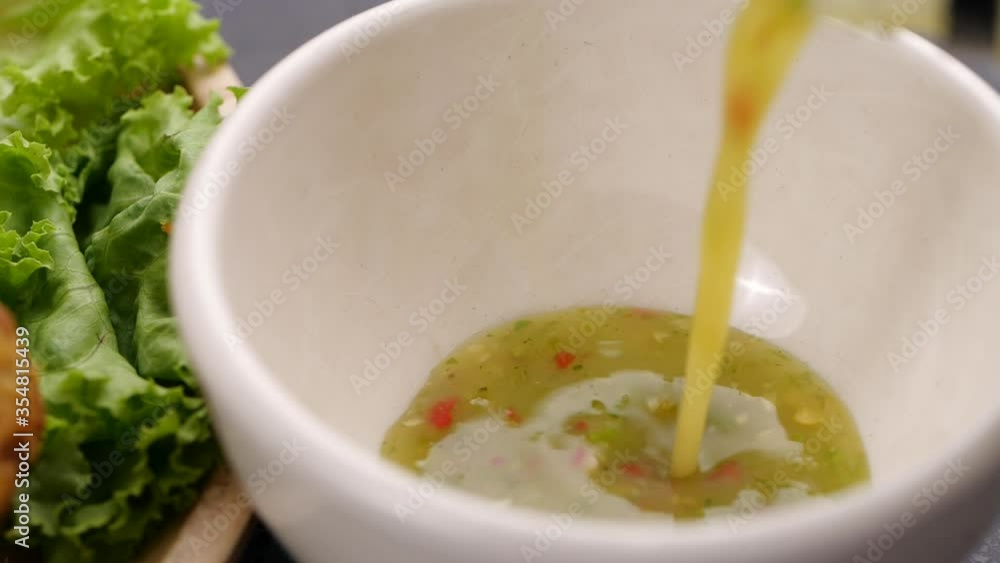 Pouring Thai spicy seafood sauce in slow motion Pouring Thai spicy seafood sauce in slow motion